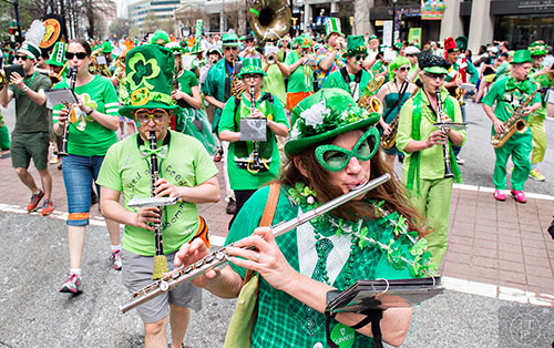 Charlotte Kilbride plays the flute as she marches down Peachtree St. during the annual Atlanta St. Patrick's Day Parade on Saturday, March 12, 2016. 
