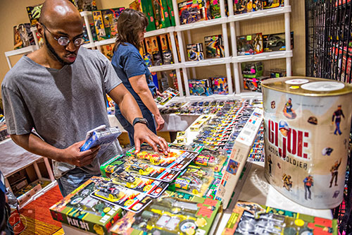 Antonio Leftwich (left) makes decisions on which G.I. Joe figures to purchase during Joelanta and the Great Atlanta Toy Convention at the Marriott Century Center in Atlanta on Saturday, March 12, 2016. 