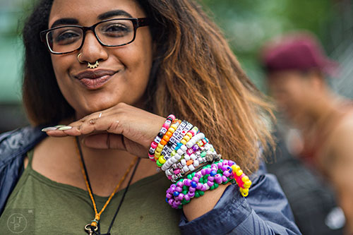 Kelsie Bradshaw shows off her bracelets during the first day of the Shaky Beats Music Festival at Centennial Olympic Park in Atlanta on Friday, May 20, 2016. 