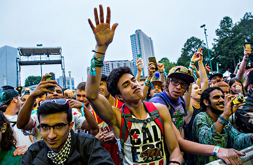 Guillermo Torres (center) dances as Jai Wolf performs during the first day of the Shaky Beats Music Festival at Centennial Olympic Park in Atlanta on Friday, May 20, 2016. 