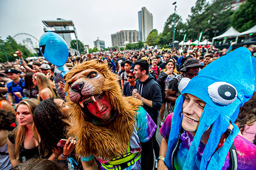 Arran Krantz (center) and Alexander Herman dance as Jai Wolf performs during the first day of the Shaky Beats Music Festival at Centennial Olympic Park in Atlanta on Friday, May 20, 2016. 