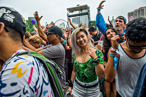 Ruth Lam (center) dances as Jai Wolf performs during the first day of the Shaky Beats Music Festival at Centennial Olympic Park in Atlanta on Friday, May 20, 2016. 
