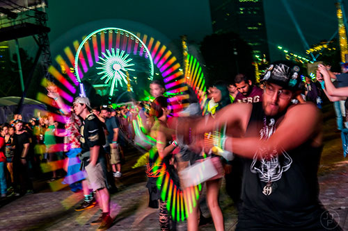 Jullian Darth-Faust spins glow sticks as Duke Dumont performs during the first night of the Shaky Beats Music Festival at Centennial Olympic Park in Atlanta on Friday, May 20, 2016. 