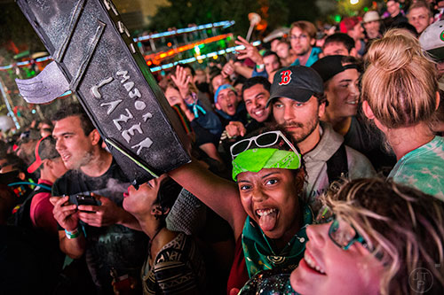 Sydnee Wade (center) lifts her lazer gun in the air as she waits for Major Lazer to perform during the first night of the Shaky Beats Music Festival at Centennial Olympic Park in Atlanta on Friday, May 20, 2016. 