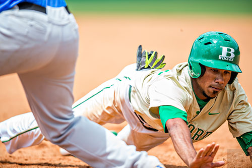 Buford's Nick Wilhite (right dives back to first base as Locust Grove's Clay Shearouse tries to pick him off during the GHSA Class AAAA Championship Baseball Tournament in Buford on Saturday, May 21, 2016.
