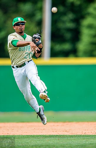 Buford's Austin Wilhite (20) leaps into the air as he throws the ball towards first base during their game against Locust Grove during the GHSA Class AAAA Championship Baseball Tournament in Buford on Saturday, May 21, 2016.