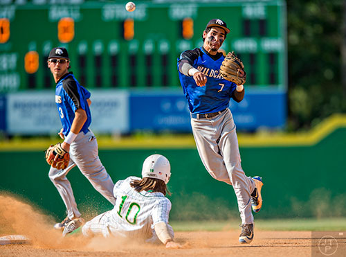 Locust Grove's Odlanier Rodriguez (7) turns the double play as Buford's Brandon Marsh (10) slides towards second base during the final game of the Class AAAA baseball championships in Buford on Monday, May 23, 2016. 