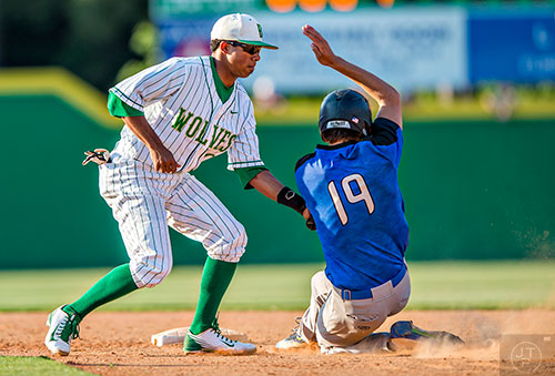 Buford's Austin Wilhite (left) tags out Locust Grove's Ethan Lindow (19) as he slides into second base during the final game of the Class AAAA baseball championships in Buford on Monday, May 23, 2016. 