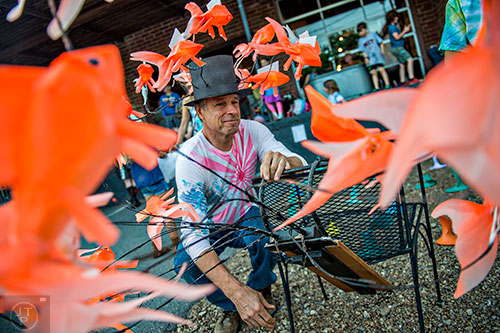 Dave Lind (left) prepares his goldfish lantern as he waits for the start of the third annual Decatur Lantern Parade on Friday.