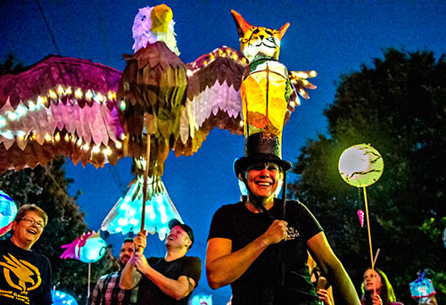 Kira Wilsterman (right) and Nick Madden walk down E. Ponce during the third annual Decatur Lantern Parade on Friday.