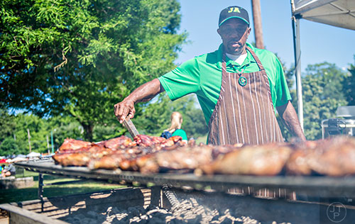 Alva Bramwell tends to a grill full of chicken during the Kirkwood Spring Fling on Saturday.