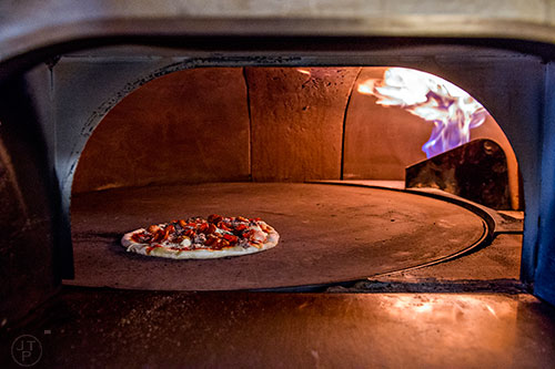 A pizza bakes in the oven at Atwood's in Midtown.