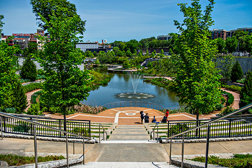 Ponce City Market can be seen in the distance from the top of the stairs overlooking the lake at Historic Fourth Ward Park.