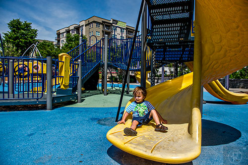 Dean Brooks enjoys himself on the playground at Historic Fourth Ward Park. Camden Fourth Ward overlooks the playground and the grounds.