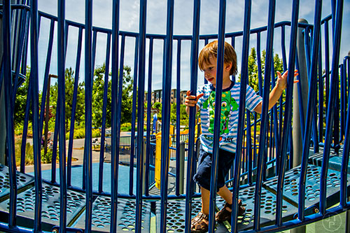 Dean Brooks enjoys himself on the playground at Historic Fourth Ward Park.