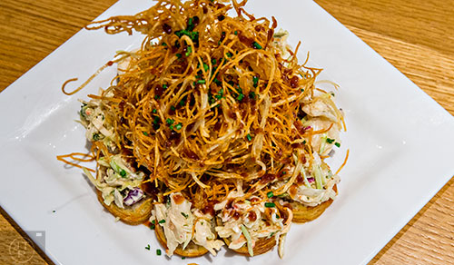 Cowfish serves up the Deliverance roll with pulled pork, caramelized onions, and barbeque sauce wrapped in soy paper and potato strings and flash fried and then topped with housemade bacon coleslaw and chives.