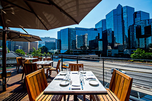 An upper outdoor patio at South City Kitchen gives views of Peachtree Rd. in Buckhead.