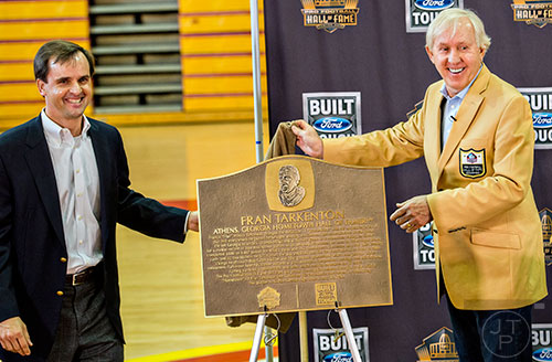 Fran Tarkenton (right) unveils the hometown heroes plaque during a presentation at Clarke Central High School in Athens on Tuesday, May 10, 2016.