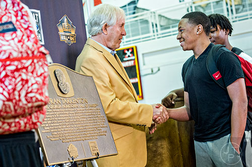 Fran Tarkenton (left) shakes hands and speaks to members of the current football team at Clarke Central High School in Athens on Tuesday, May 10, 2016.