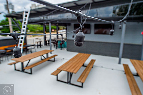 With a few finishing touches to go lights are being strung across the rooftop patio at Grind House Killer Burgers in Decatur.