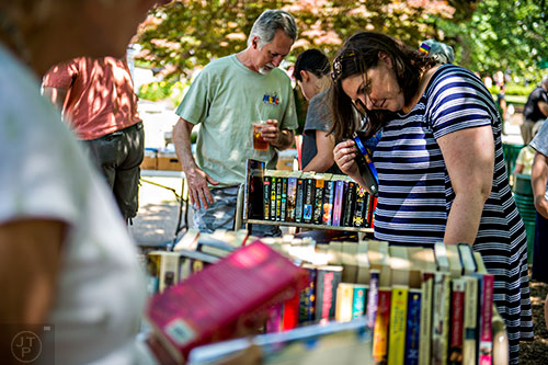 Melissa Kotun (right) and Charles Weyant check out books for sale during the Decatur Arts Festival on Saturday.