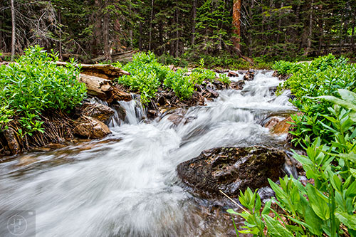 Snow melt rages down the mountains along the Loch Vale trail inside Rocky Mountain National Park in Colorado on Wednesday, June 22, 2016.