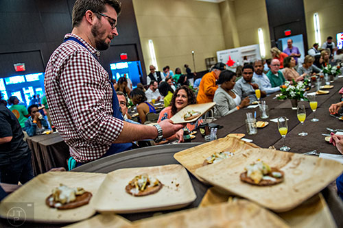 Chefs explain their dishes as they pass them out at brunch during the Atlanta Food & Wine Festival on Sunday