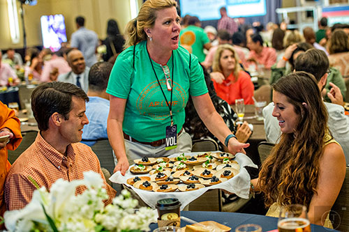 Volunteers help serve brunch during the Atlanta Food & Wine Festival on Sunday.