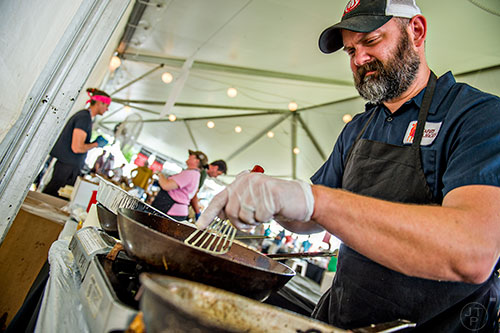 The guys at Farm Burger prep their decimal place goat cheese grit cakes at the tasting tents in Piedmont Park during the Atlanta Food & Wine Festival on Sunday.