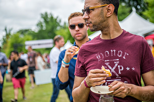 Grabbing a bite to eat at the tasting tents in Piedmont Park during the Atlanta Food & Wine Festival on Sunday.