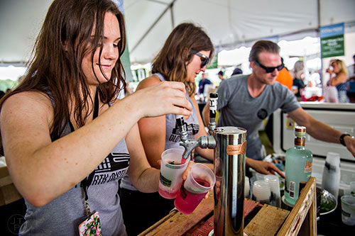 The crew from Fourth Ward Distillery pour drinks at the tasting tents in Piedmont Park during the Atlanta Food & Wine Festival on Sunday.