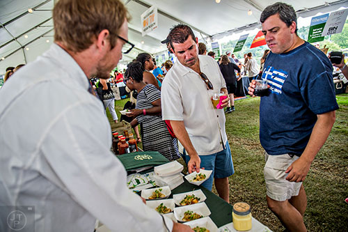 People come to White Oak Pastures' table to try the grub at the tasting tents in Piedmont Park during the Atlanta Food & Wine Festival on Sunday.
