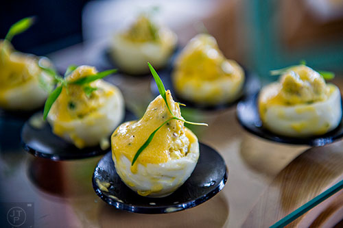 Hollandaise sauce covers crab stuffed eggs at the tasting tents in Piedmont Park during the Atlanta Food & Wine Festival on Sunday.