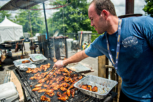 Grilling chicken at the tasting tents in Piedmont Park during the Atlanta Food & Wine Festival on Sunday.