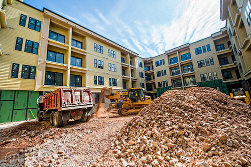 Moving dirt to make room for the pool and courtyard amenities at 675 N. Highland.