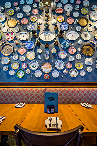 Some of the wall art at Tupelo Honey includes different china plates and silverware.