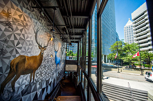 The mural and views of the city as you walk the stairs up to the lounge and outdoor patio inside 5Church at Colony Square Mall off of Peachtree St. in Atlanta.