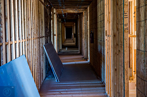 Light filters through the wooden hallways of the apartments attached to Glenwood Place in Atlanta.