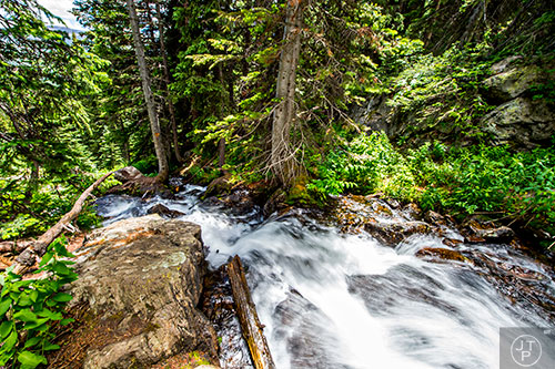 Water flows down the mountains along the trail leading to Dream Lake inside Rocky Mountain National Park in Colorado on Monday, July 12, 2016.