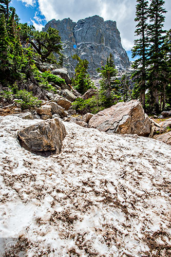 Snow is still packed along the trail leading to Emerald Lake inside Rocky Mountain National Park in Colorado on Monday, July 12, 2016.