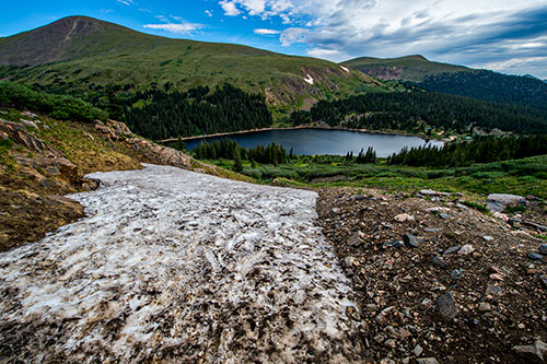A small snow field that is melting into Naylor Lake along Silver Dollar Lake Trail outside of Georgetown, Colorado on Sunday, July 24, 2016.
