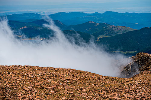 Clouds come up the face of Pikes Peak on Sunday, August 21, 2016.