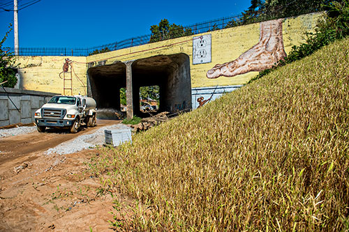 A water truck sprays along the Westside Trail of the Atlanta Beltline as it passes underneath Cascade Ave.