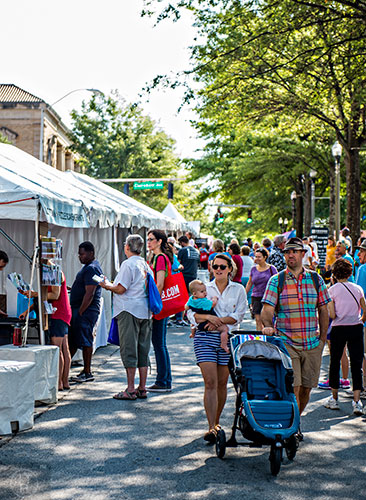 Angus Galloway (right), his wife Amanda and son Lachlan walk past the numerous booths during the Decatur Book Festival on Saturday. Photo: Jonathan Phillips