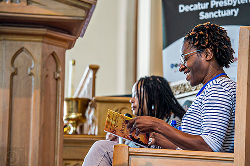 Author Jacqueline Woodson (right) reads an excerpt from her newest novel "Another Brooklyn" during the Decatur Book Festival on Saturday.