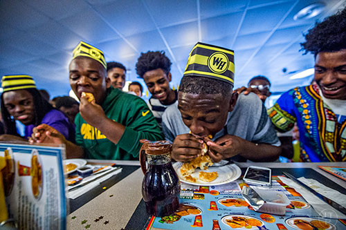 Jonah Wildgoose makes a move to tie Jason McLin during the first round of the waffle eating contest at the Waffle House off of Decatur Square on Friday.
