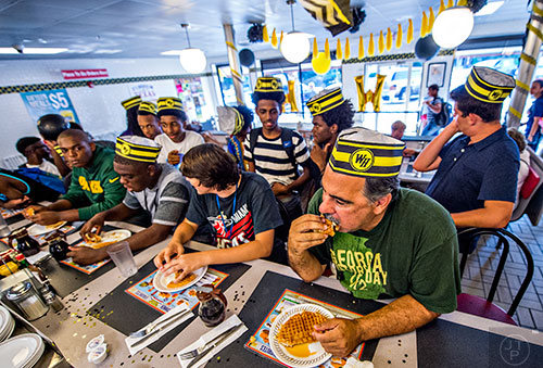 Steve Schultz, Jacob Poe, Jonah Wildgoose and Jason McLin compete in the championship round of the waffle eating contest at the Waffle House in Decatur on Friday.