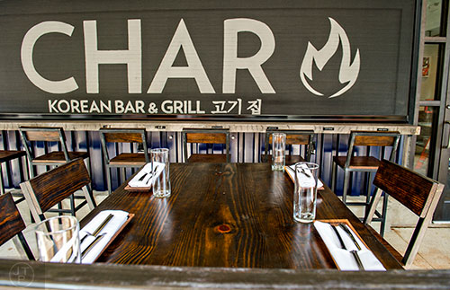 The outdoor patio at Char features a retractable bar window that allows for easy service outside.