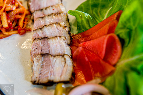Char serves up the Bossam, spice braised pork with lettuce wraps.