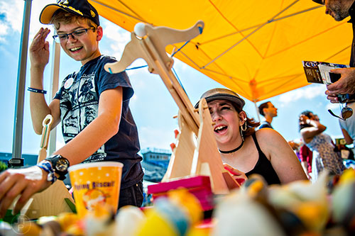 Aisling McHenry-Stelle (right) and Otto Hillegass use catapults during the Atlanta Maker Faire in Decatur on Saturday.